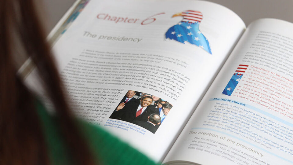 Photograph of a student reading a politics book.