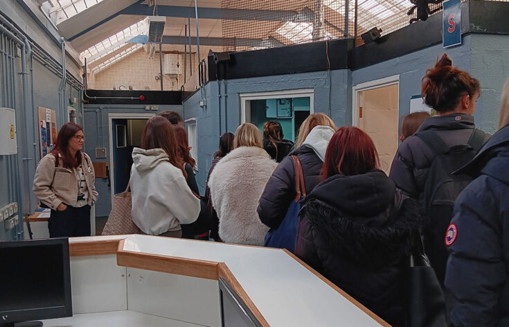 Photograph of law students being shown round a prison.
