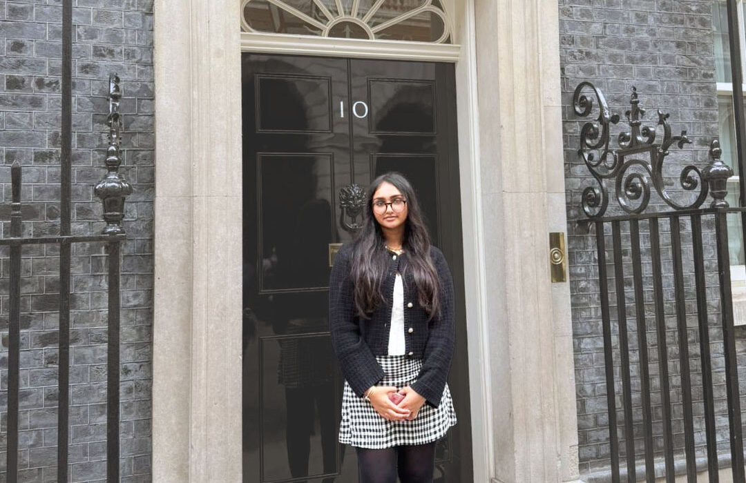 Photograph of an economics student stook outside 10 Downing Street