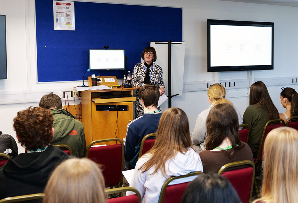 Photograph of ex staff member Catherine Eaton giving a talk to students