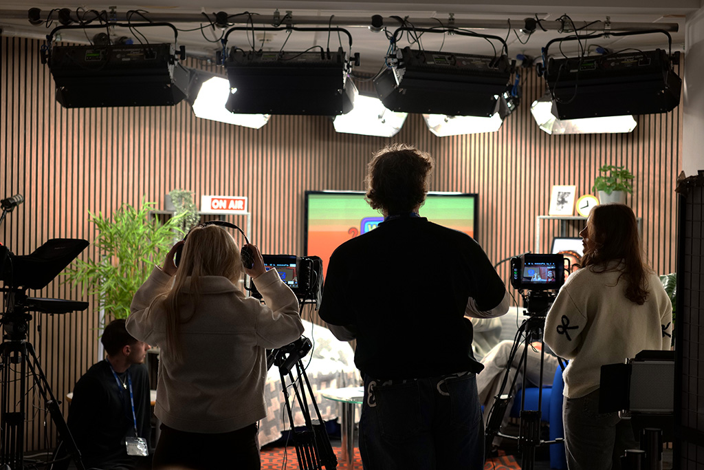 Students operating cameras in the TV studio.