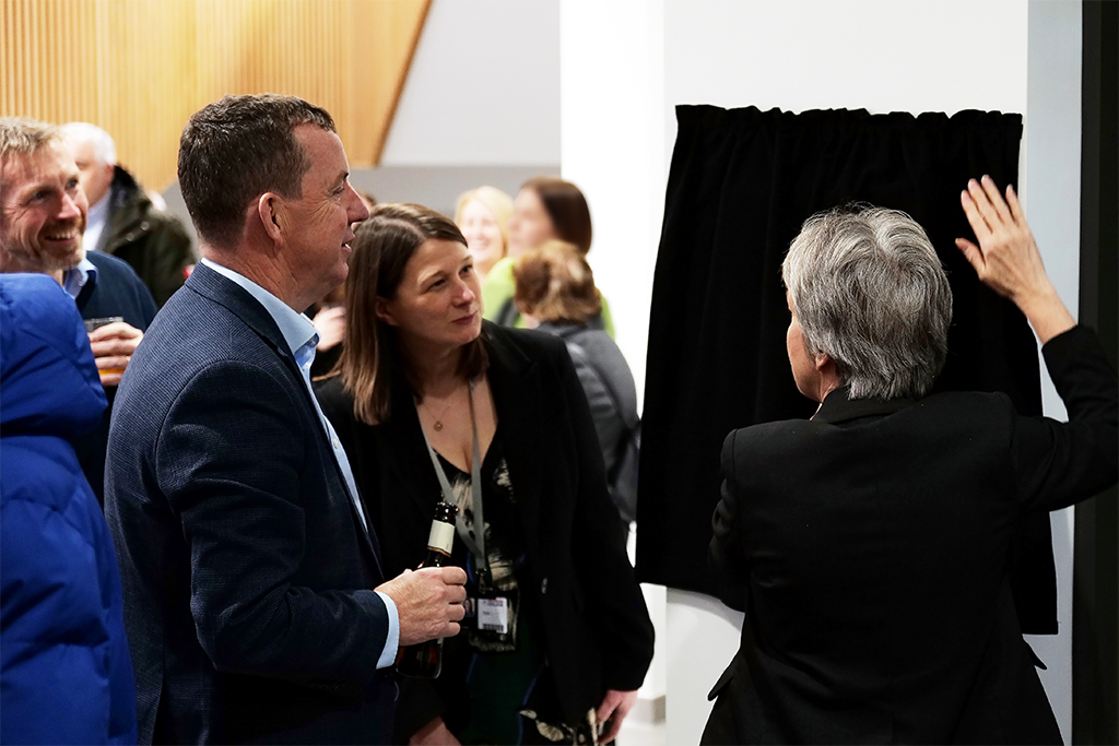 Photograph of ex principle Danny and current principle Jo getting ready to reveal the plaque.