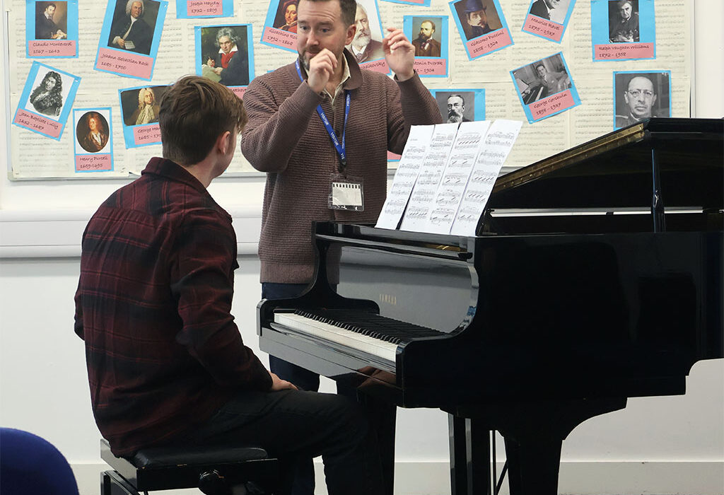 Photograph of a student receiving a masterclass in performing the piano