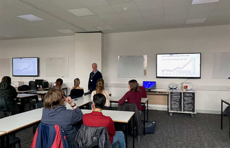 Photograph of Ambrose Smith delivering a talk on climate change