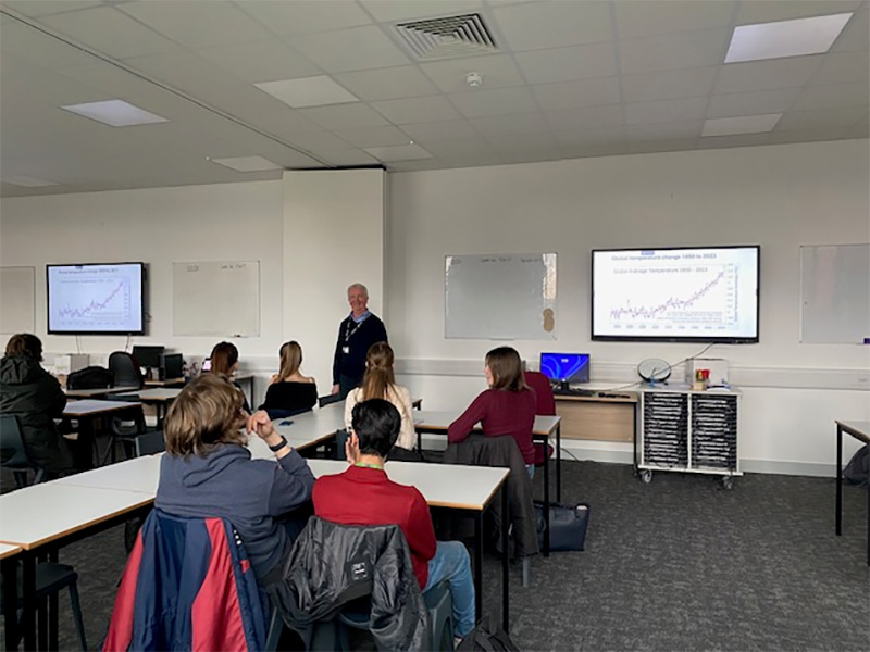 Photograph of Ambrose Smith delivering a talk on climate change