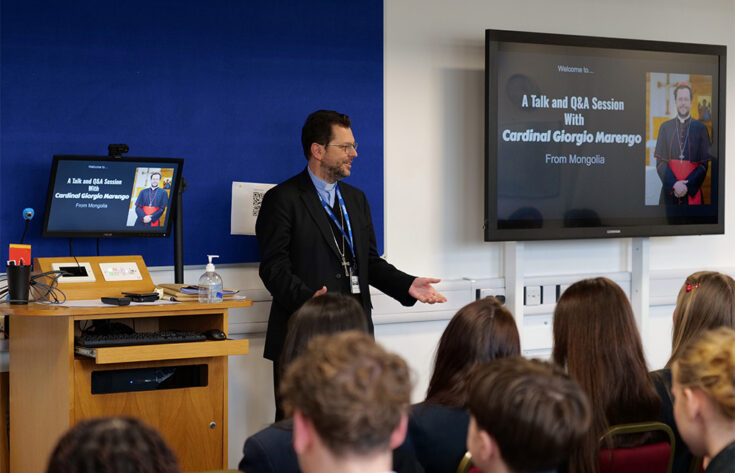 Photograph of cardinal Cardinal Giorgio Marengo answering questions from students.