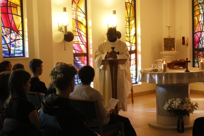 Photograph of students and staff attending a feast service in the chapel.