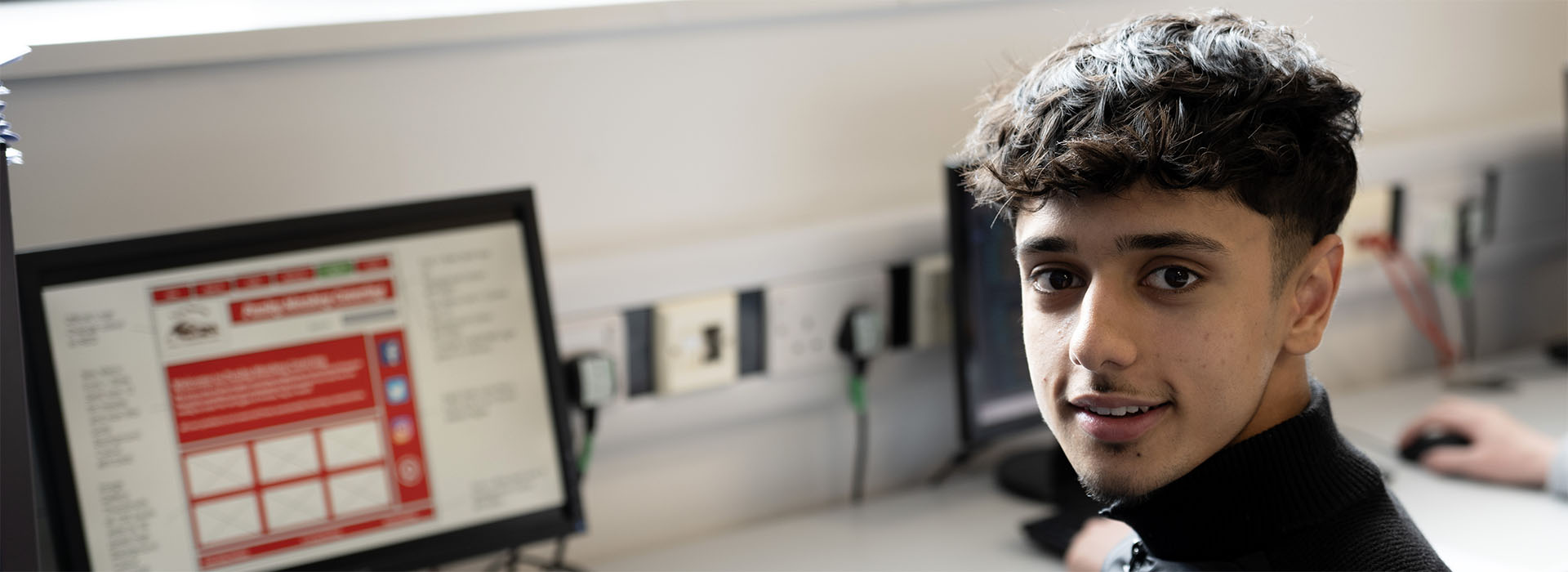 Cropped photograph of a student working on an IT project
